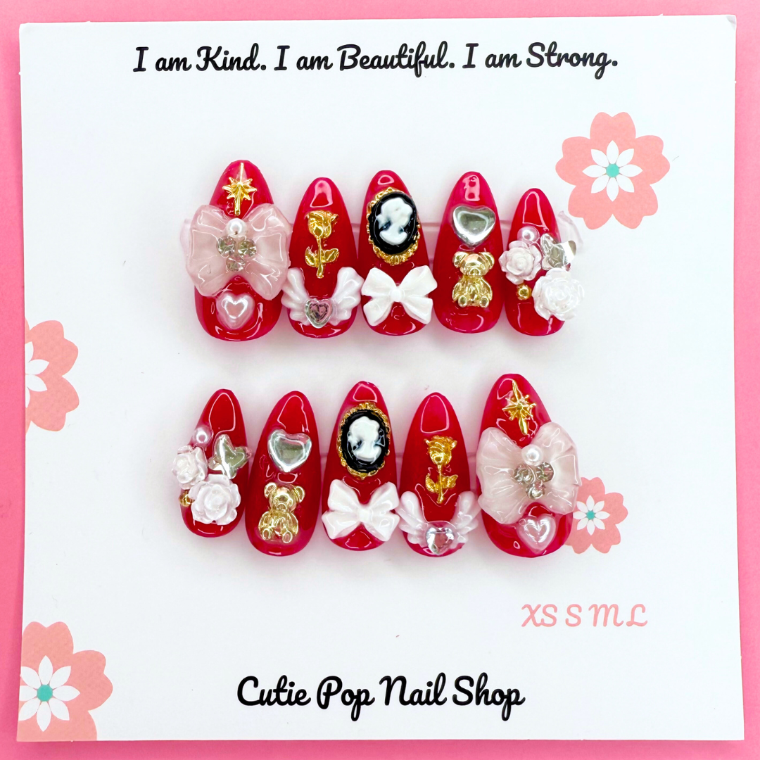Red Victorian Shadows press-on almond nails by Cutie Pop Nail Shop with elegant Victorian design.