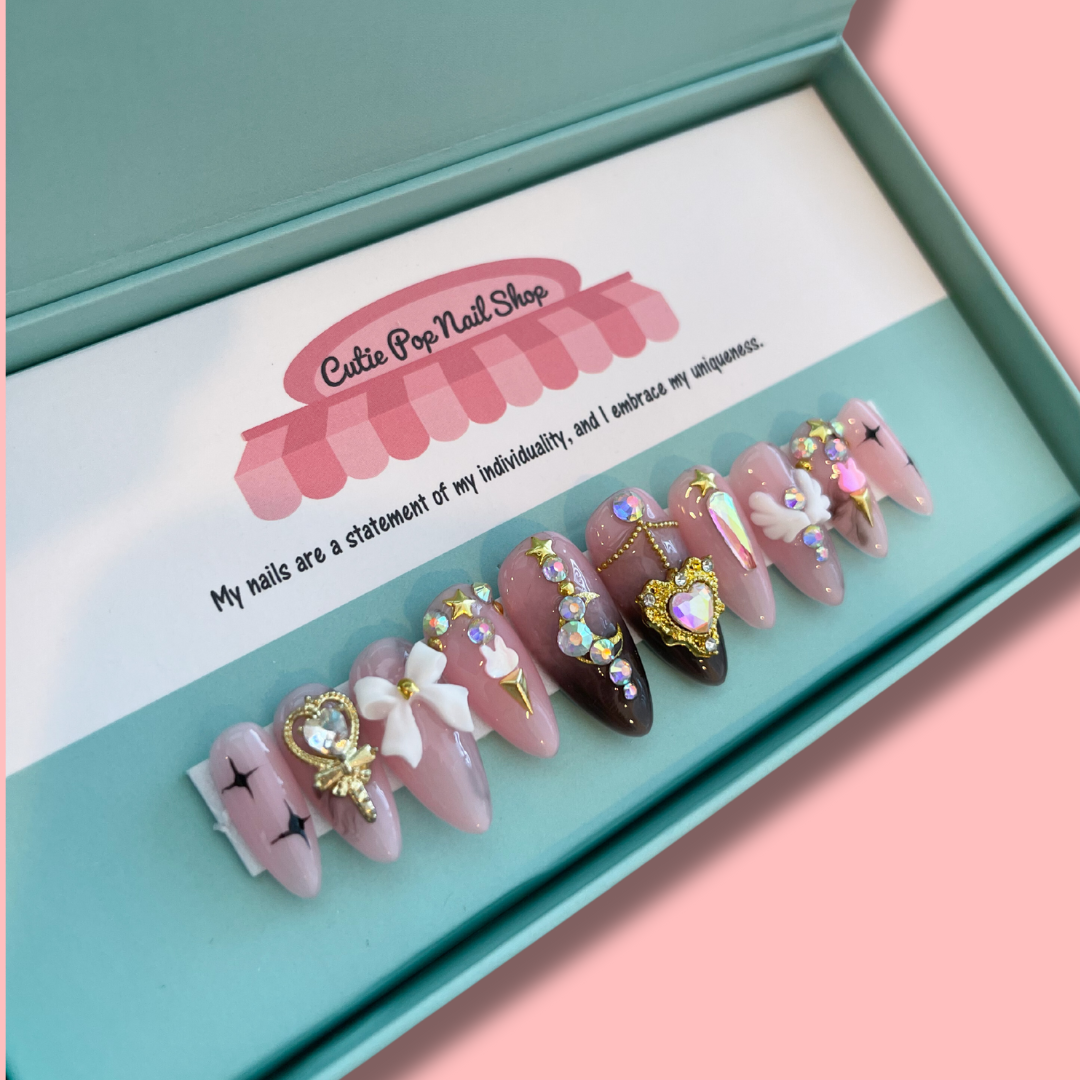 Dark purple almond-shaped press-on nails with moon and princess motifs from Cutie Pop Nail Shop&