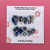 Medium coffin-shaped press-on nails with Bougie Bling 17 design by Cutie Pop Nail Shop featuring shiny, decorative nail art.