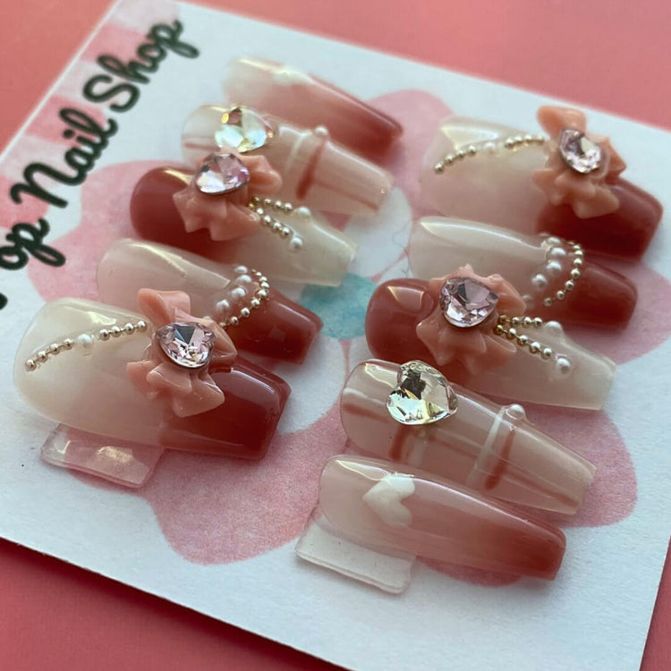 Medium coffin-shaped press on nails in soft girly pink from Cutie Pop Nail Shop, featuring a stylish, feminine design.