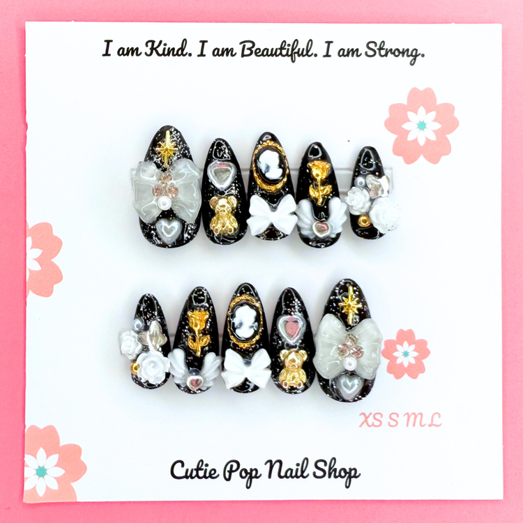 Victorian Shadows press-on coffin nails from Cutie Pop Nail Shop with intricate dark floral design, medium length, elegant nail art.