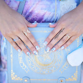 Blue coffin-shaped press on nails with an elegant rose design by Cutie Pop Nail Shop, showcasing a stylish, easy-to-wear manicure.