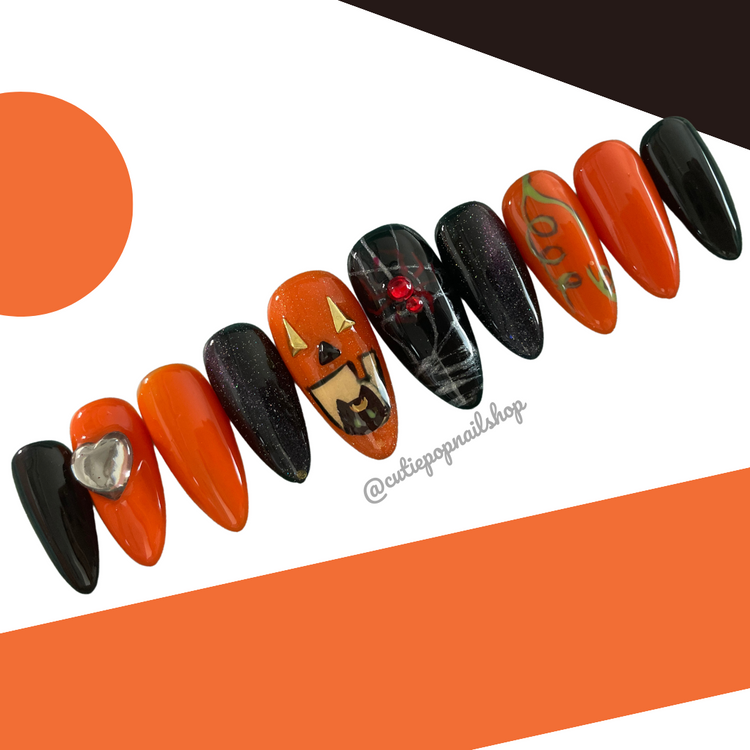Small Pumpkin Cat press-on nails by Cutie Pop Nail Shop featuring a cute pumpkin and cat design on natural-looking nails.