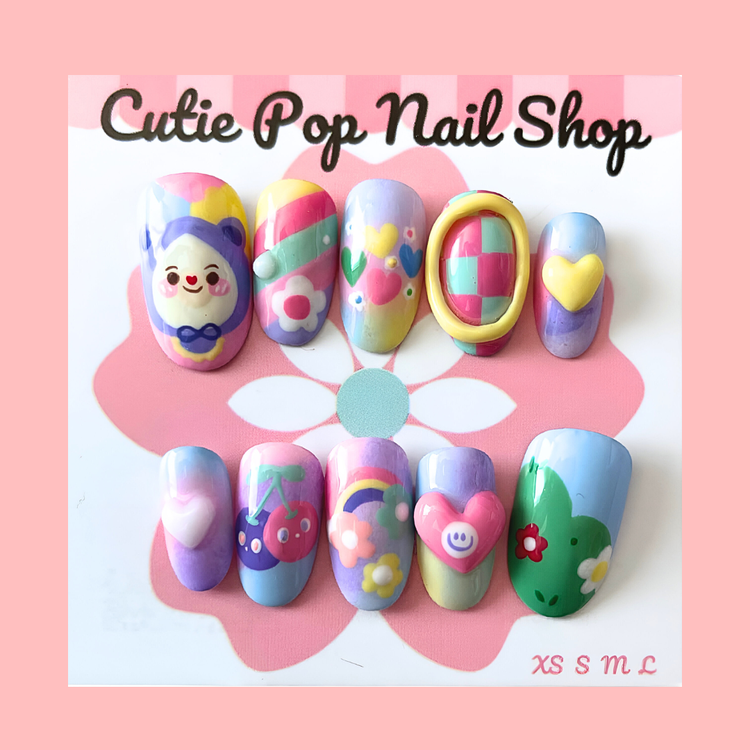 Pastel Friends press-on nails by Cutie Pop Nail Shop with round short shape and colorful pastel designs.