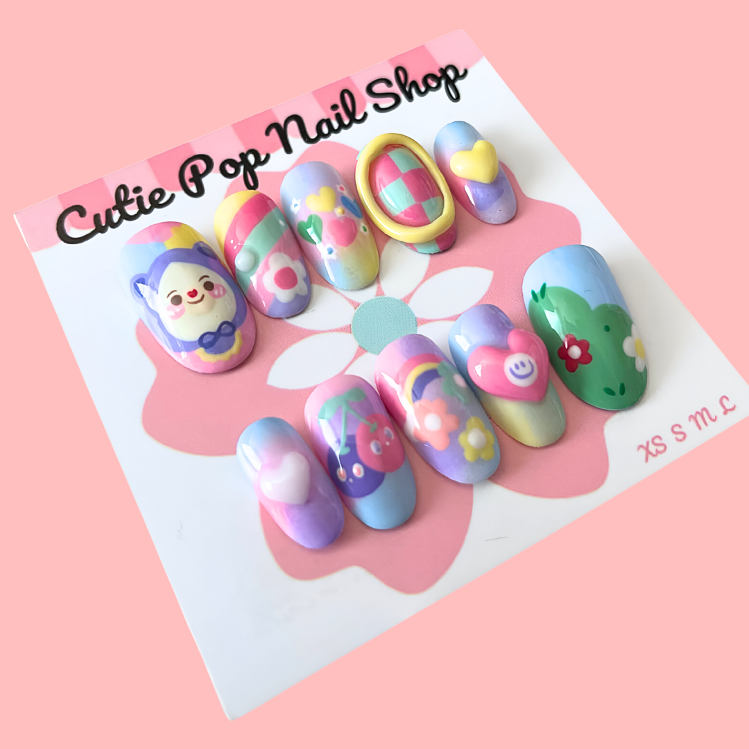 Pastel Friends press on nails by Cutie Pop Nail Shop featuring round short XS nails with pastel-colored fun designs