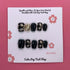 Short squoval press-on nails in a classy harlequinn design by Cutie Pop Nail Shop, showcasing elegant nail art and glossy finish.