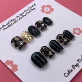Extra short squoval press-on nails in a classy Harlequinn design by Cutie Pop Nail Shop, displayed on a white background.