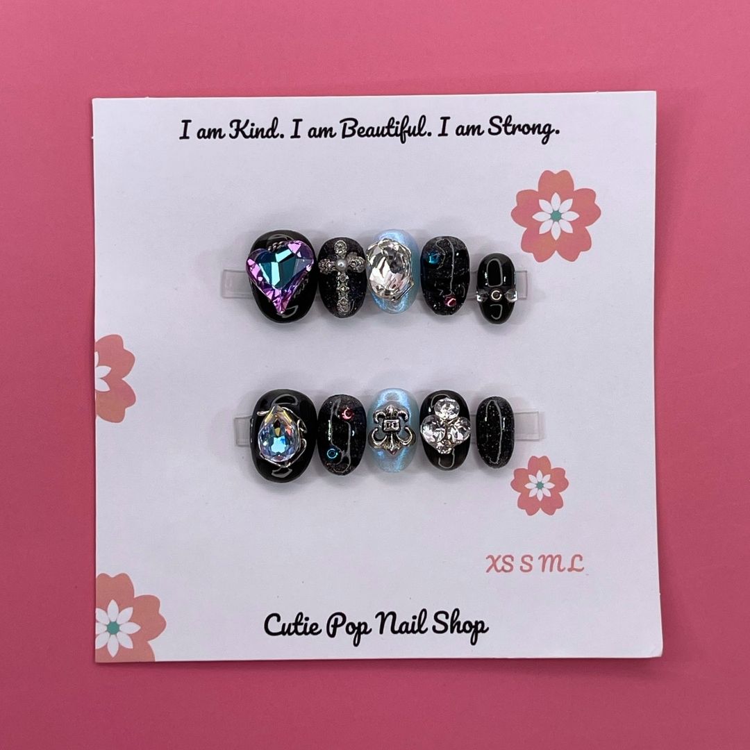 Cosmic Goth press-on nails from Cutie Pop Nail Shop featuring dark cosmic design and glossy finish.