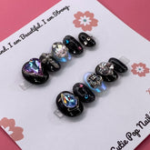 Cosmic Goth press-on nails from Cutie Pop Nail Shop featuring dark, cosmic-themed nail art on short, stylish nail tips.