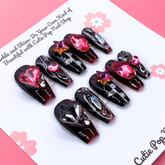 Gothic Ruby press-on nails by Cutie Pop Nail Shop featuring deep red and black gothic design on short nail tips.
