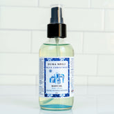 Blue Christmas Body Oil by Duma Mbili LLC in a 4 oz bottle, featuring a vibrant blue color and festive holiday packaging.