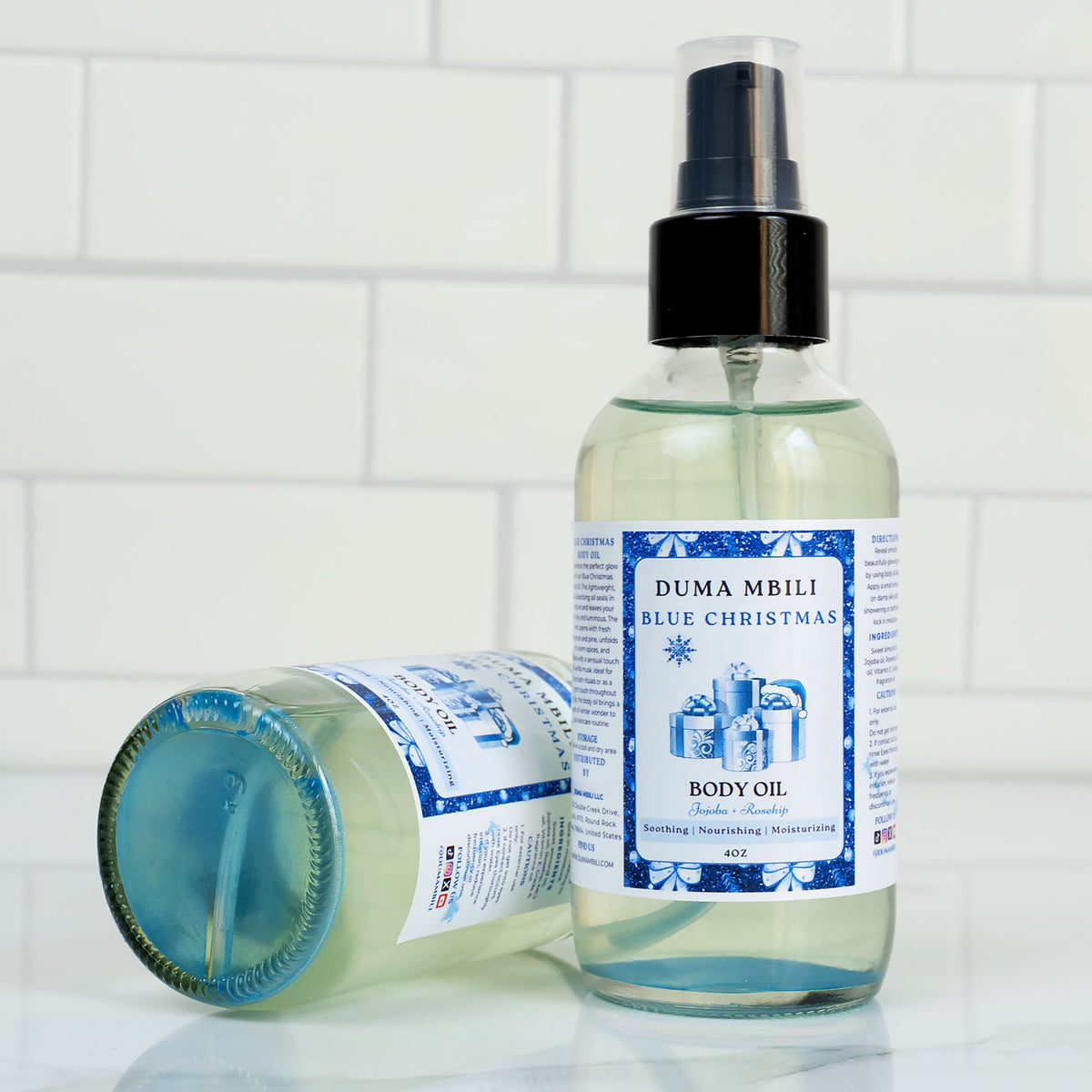 Blue Christmas Body Oil by Duma Mbili LLC in a 4 oz bottle, showcasing the vibrant blue color and elegant packaging.