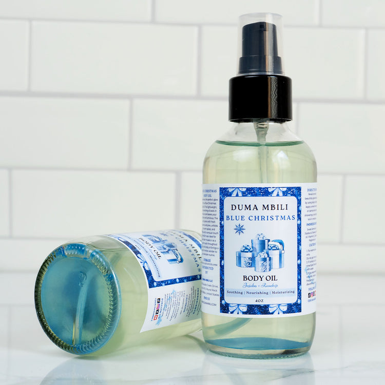 Blue Christmas Body Oil by Duma Mbili LLC in a 4 oz bottle, showcasing the vibrant blue color and elegant packaging.