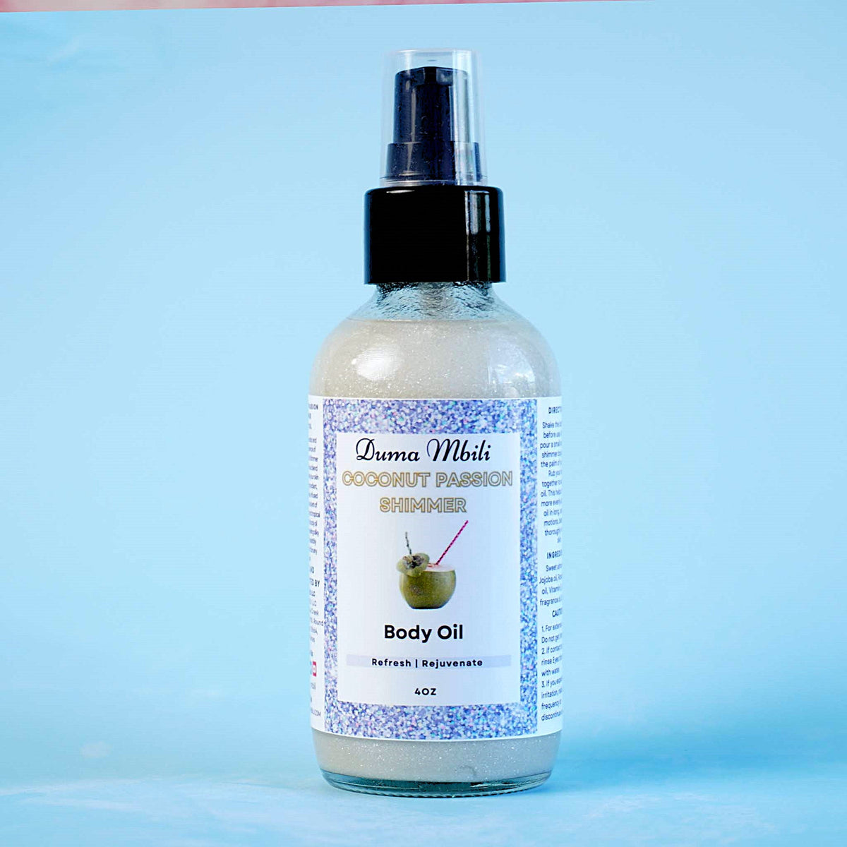 Duma Mbili LLC Coconut Passion Shimmer Body Oil in a 4 oz bottle, with a glossy label and transparent cap, showcasing a shimmering oil.