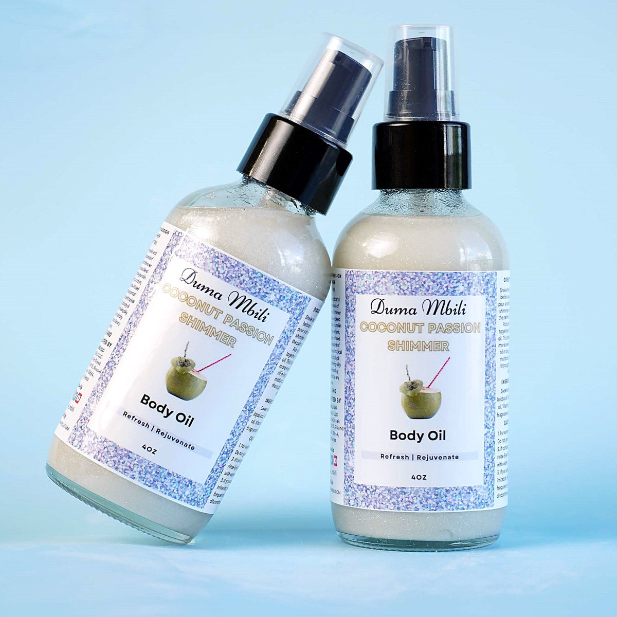 Duma Mbili LLC Coconut Passion Shimmer Body Oil in a 4 oz bottle with a sleek design and golden shimmer accents.