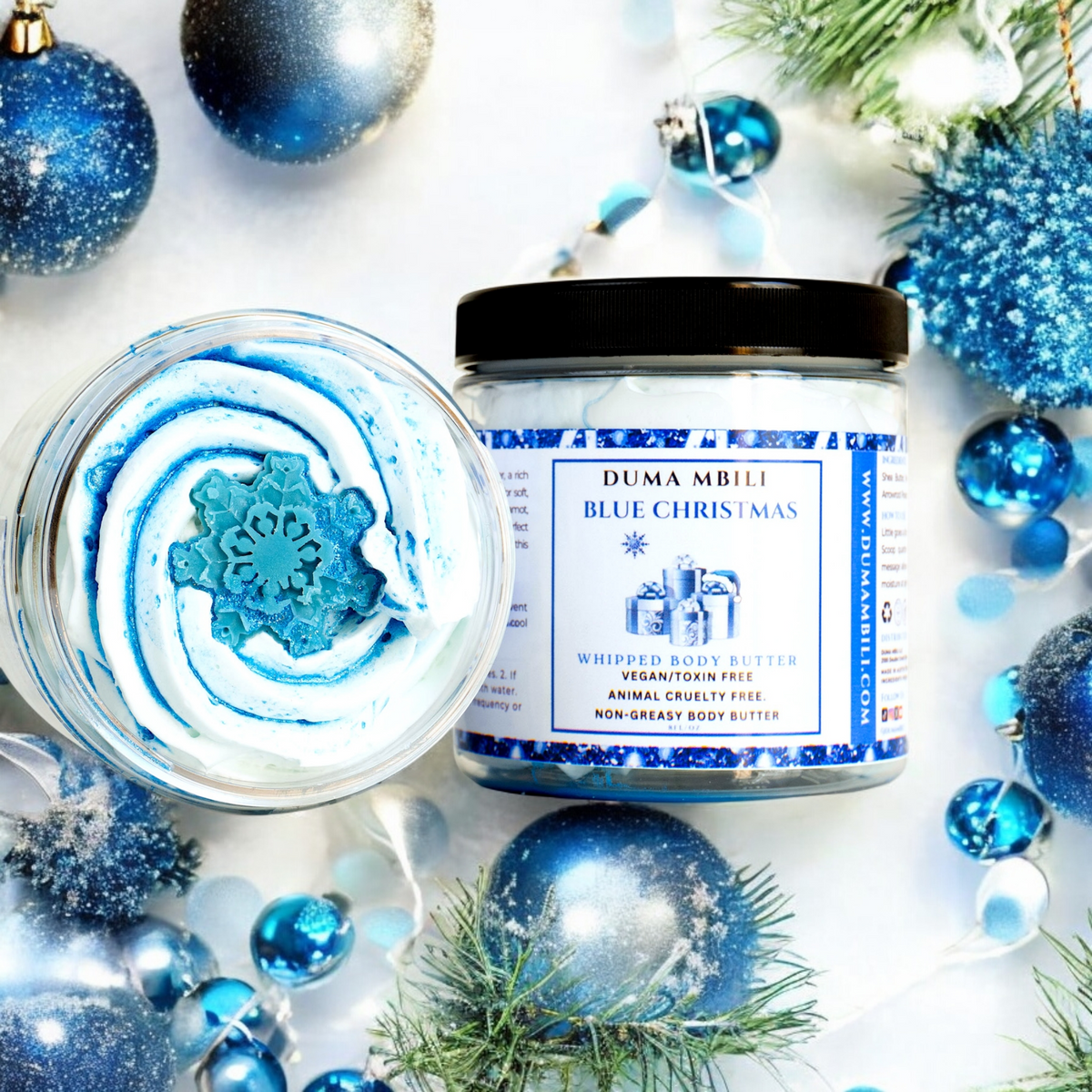 Blue Christmas whipped body butter by Duma Mbili LLC in an 8 oz jar, showcasing its creamy, fluffy texture and festive holiday packaging.