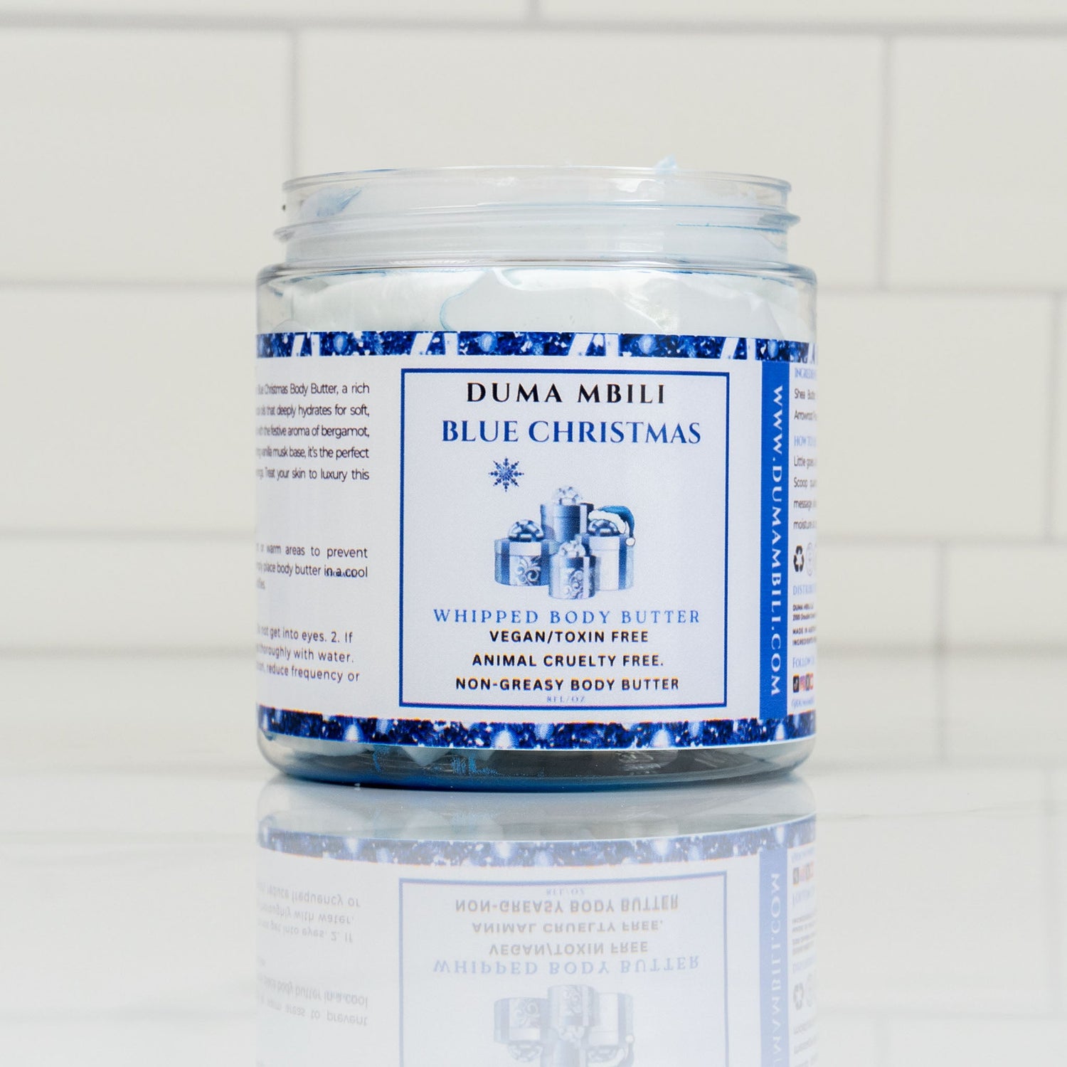 Blue Christmas whipped body butter from Duma Mbili LLC, creamy and fluffy in a jar with festive holiday packaging.