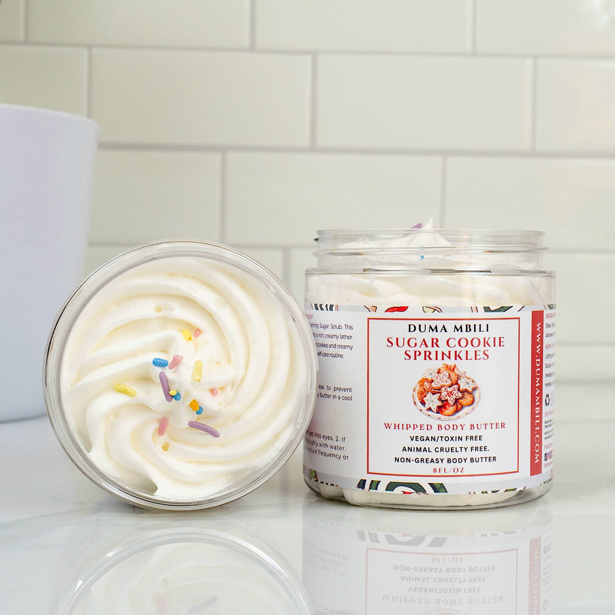 Duma Mbili LLC Sugar Cookie Sprinkles whipped body butter in an 8 oz jar with colorful sprinkle design on the label.