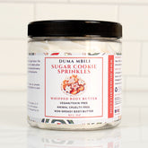 Duma Mbili LLC Sugar Cookie Sprinkles Whipped Body Butter in an 8 oz jar with a smooth, creamy texture and colorful sprinkle design.