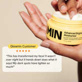 Gleamin Advanced Brightening Facial Moisturizer with smooth cream texture and brightening ingredients in a jar.
