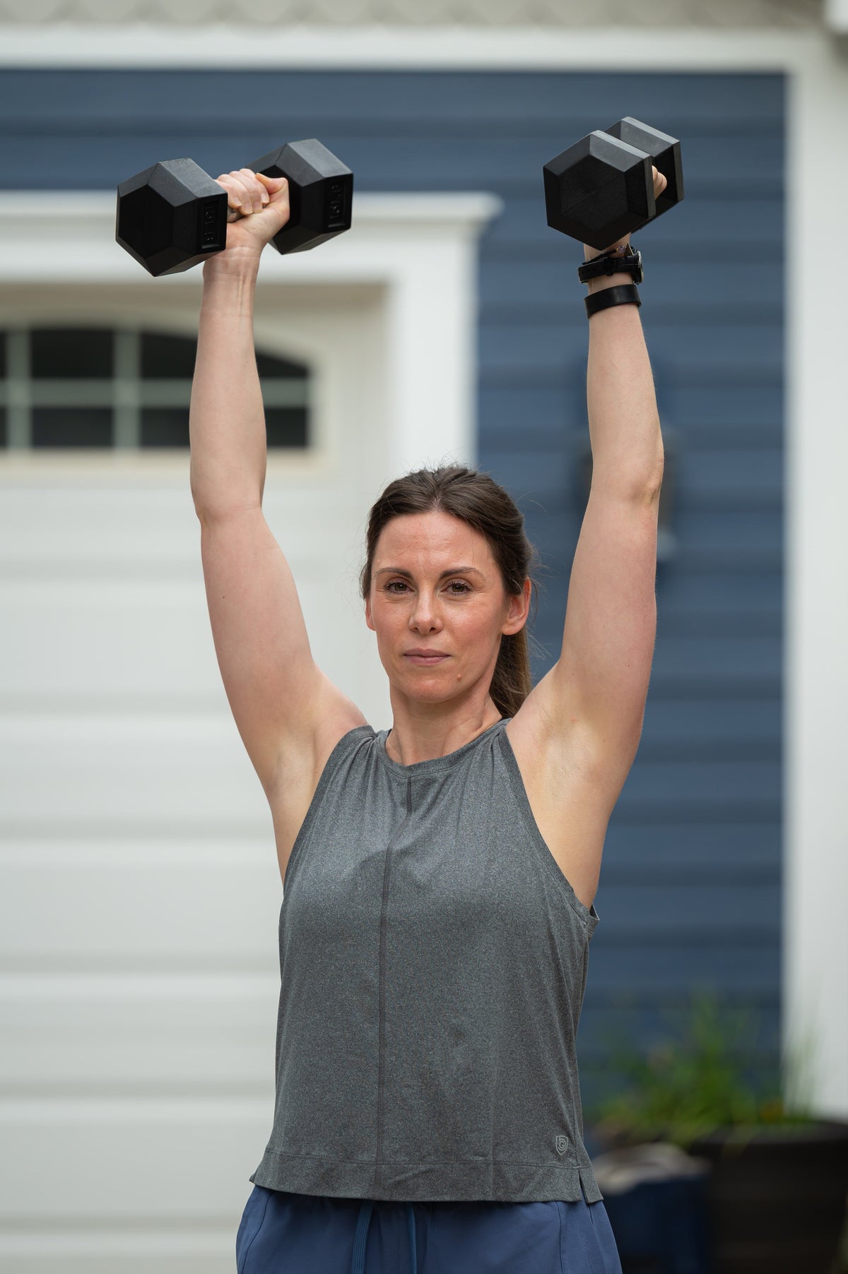 Dark grey Goal Five boxy crop tank top shown on a model, featuring a relaxed fit and sleeveless design.
