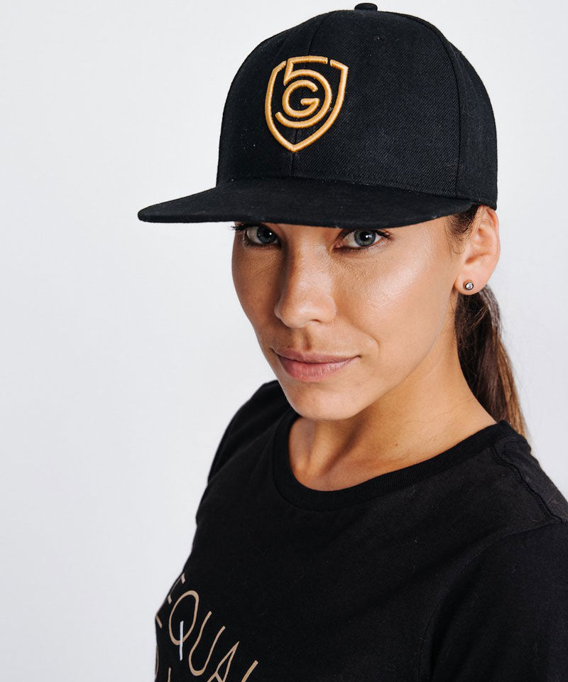 Goal Five G5 Flat Billed Snap Back Hat in black, lifestyle image showing front view of stylish, flat-brim snapback cap.