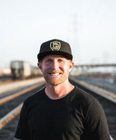 Black Goal Five G5 flat billed snap back hat with a structured crown and adjustable strap, styled for casual lifestyle wear.