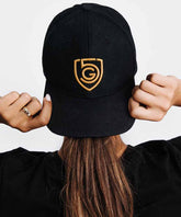 Black G5 Flat Billed Snap Back Hat by Goal Five, lifestyle image showcasing the stylish, flat-brim baseball cap.