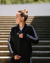 Black Goal Five Powerstripe LS Track Jacket for lifestyle wear, shown on a model in a casual setting.