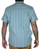 Mid-blue Daryll SS shirt by Off The Grid Surplus, a stylish button-up shirt with a classic fit and casual design.