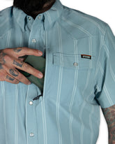 Mid-blue Daryll SS shirt by Off The Grid Surplus, a stylish button-up shirt with a classic fit and casual design.