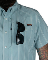 Mid blue Daryll SS shirt by Off The Grid Surplus, a stylish button-up shirt with a classic fit and clean design.