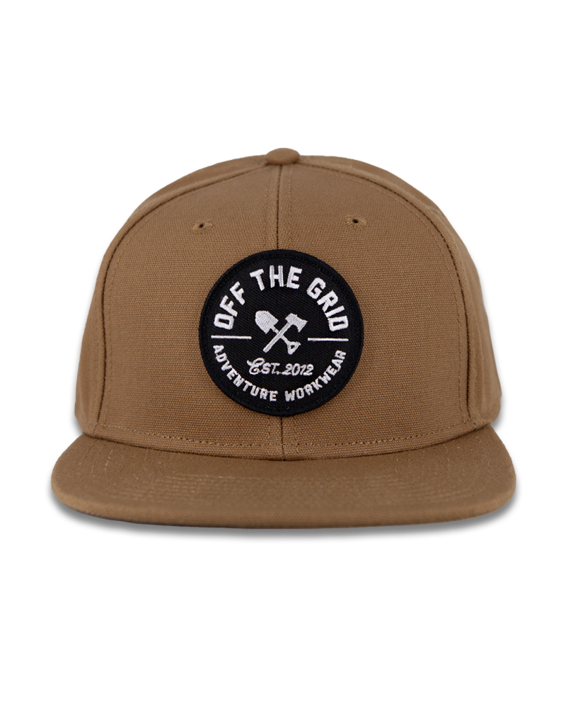 Black Off The Grid Surplus Jobsite Hat showing a sturdy cap with adjustable strap and logo patch on the front.
