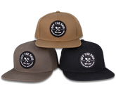 Black Off The Grid Surplus Jobsite Hat with adjustable strap and logo patch, designed for durable workwear.