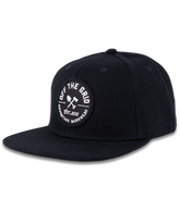 Black Off The Grid Surplus jobsite hat with adjustable strap and logo patch, designed for durability and outdoor work.