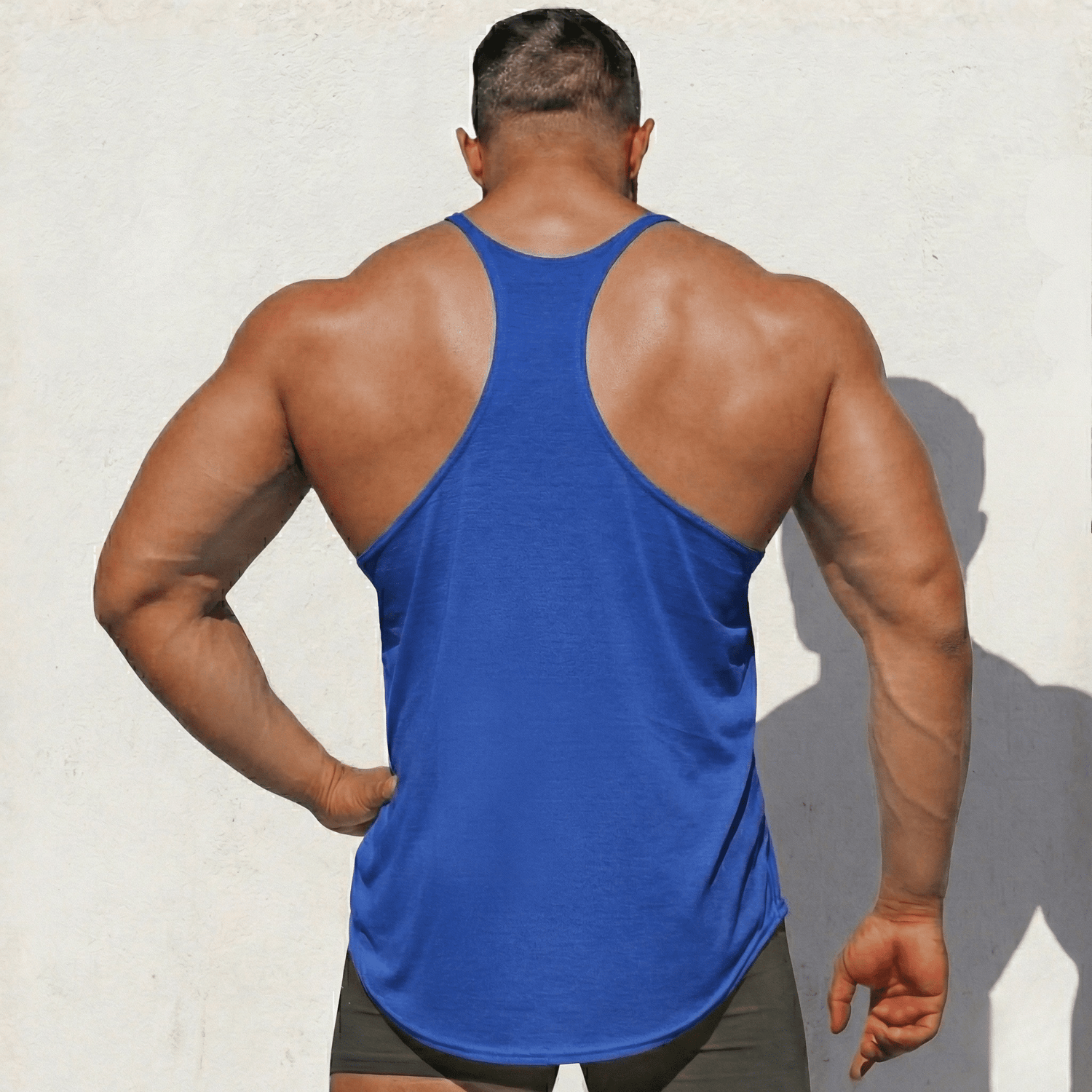 Black Physique Bodyware Stringer Tank Top with thin straps, designed for athletic and workout wear.