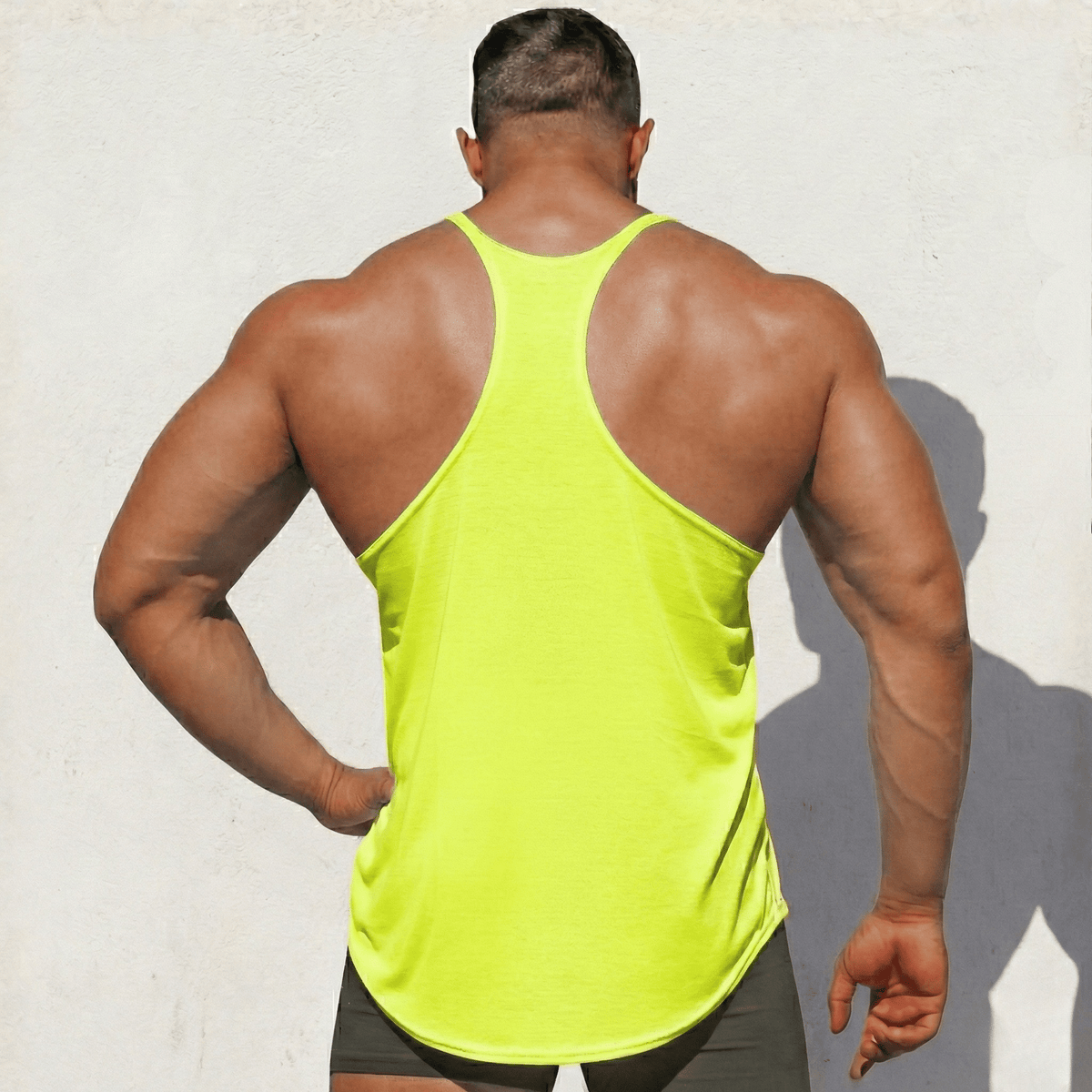 Black Physique Bodyware stringer tank top with slim fit design, suitable for workout and gym activities.