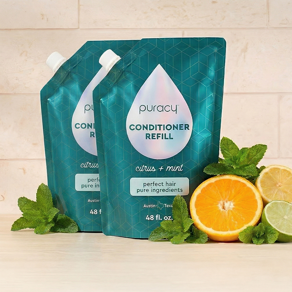 Puracy conditioner with citrus mint scent, sulfate-free and silicone-free, shown in a sleek bottle with fresh citrus and mint leaves