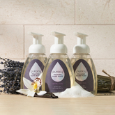 Puracy lavender vanilla foaming hand soap set of 3 in clear bottles with pump dispensers, displaying the product label and soap foam