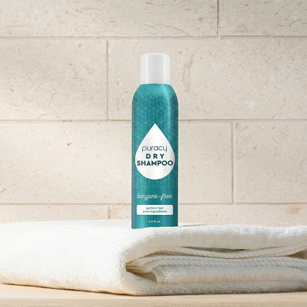 Puracy dry shampoo bottle featuring benzene and silicone-free formula, safe for color-treated hair, with a white pump top container