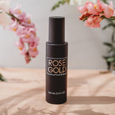 Rose Gold Sunless facial tanning mist in clear water spray bottle, designed for natural-looking sunless skin glow.