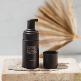 Travel size Rose Gold Sunless Self Tanning Mousse in a compact bottle for quick, natural bronze tan on the go.