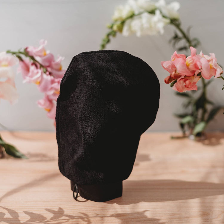 Rose Gold Sunless deep exfoliating glove for smooth skin and even tan application, featuring a soft, rose gold-colored tan applicator.