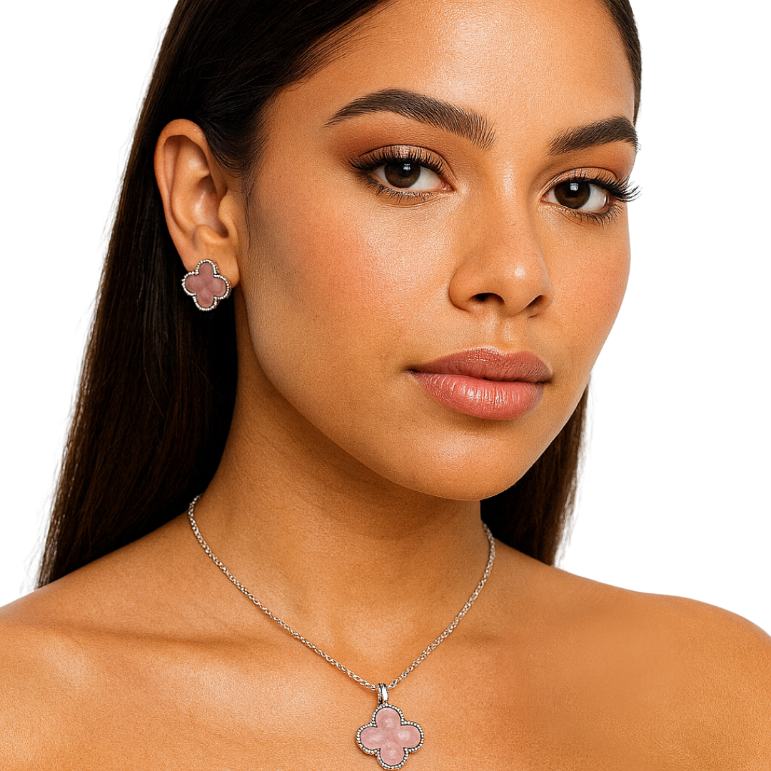 Pink clover enamel necklace and earrings jewelry set featuring floral design by Farmacias Savia.