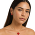 Farmacias Savia Pasión Red Clover enamel necklace and earrings jewelry set with vibrant red and green floral design.