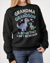 Black unisex dinosaur T-shirt from TEELUVS.COM featuring a grandma and grandson bond design, perfect for kids and family matching.