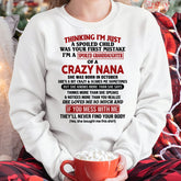 White T-shirt for kids with "Spoiled Granddaughter of a Crazy Nana" text, October edition, from TEELUVS.COM.