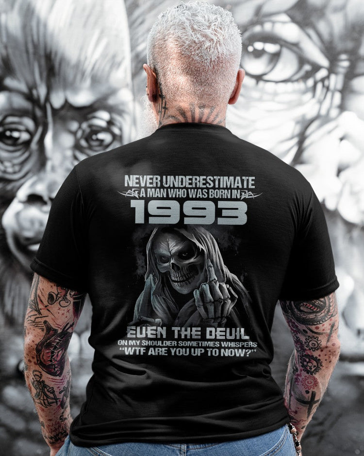 Black TEELUVS.COM T-shirt featuring "Never Underestimate Us 1993" text, casual fit, front view.