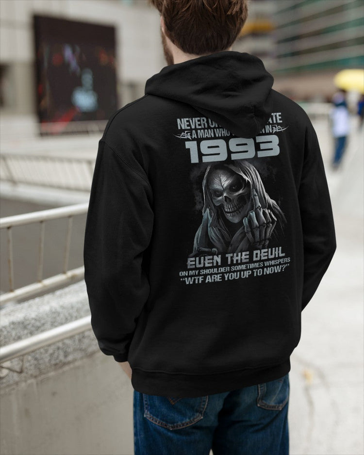 Black T-shirt from TEELUVS.COM with "Never Underestimate Us 1993" printed design, casual fit, and comfortable fabric.