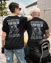 Black TEELUVS.COM T-shirt featuring "Never Underestimate Us 1993" slogan, casual fit, front view.